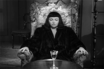 Jacqueline contemplating her forced suicide by poison in The Seventh Victim produced by Val Lewton for RKO Radio Pictures, directed by Mark Robson, starring Tom Conway, Jean Brooks, Isabel Jewell, Kim Hunter, and Hugh Beaumont